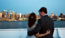 wedding on a ship in New York city - wedding couple looking at skyline