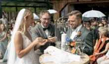 Bei der Hochzeit auf der Toni Alm entzündet das Brautpaar die Hochzeitskerze vor seinen Gästen.