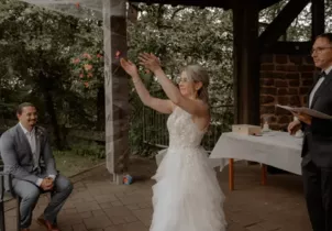 The bride bids farewell to her old name in a German-American wedding ceremony near Kaiserslautern