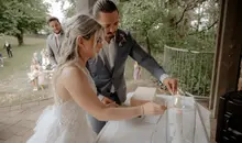 The couple lights their wedding candle in a German-American wedding ceremony near Kaiserslautern, Germany